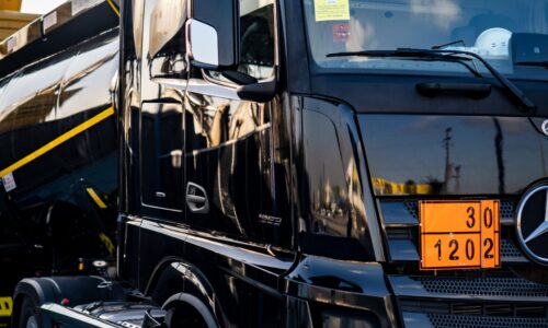 pexels-photo-16100082-16100082 Black truck with a tanker, showcasing logistics and transportation in an industrial environment.