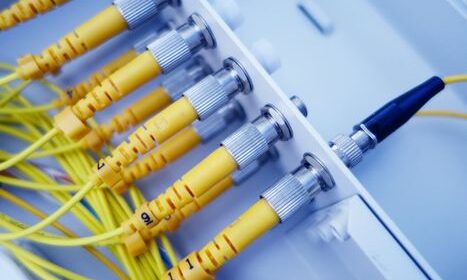 pexels-photo-37564550-37564550 Close-up of yellow fiber optic cables in a network server, showcasing fast data transfer.